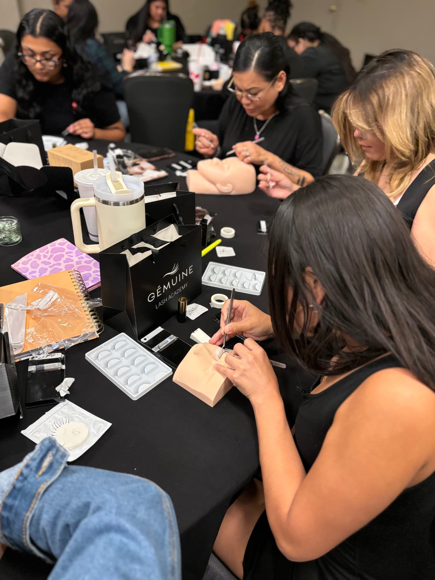 Students practicing lash application together in a Gemuine Academy class